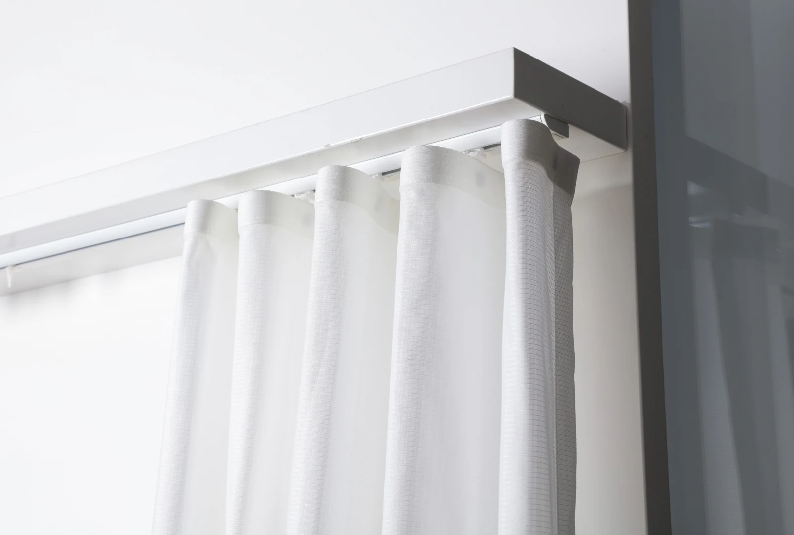 Catalog photograph of a ceiling-mounted A26 curtain track